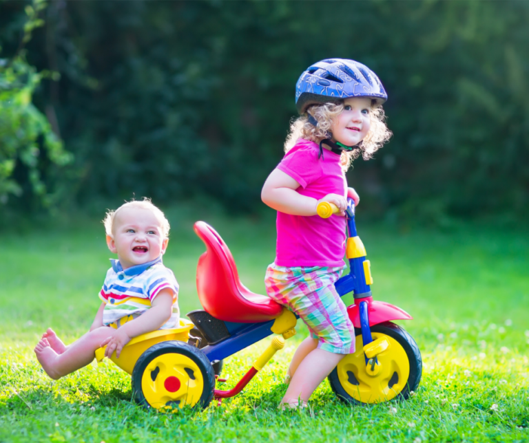 siblings-riding-tricycle