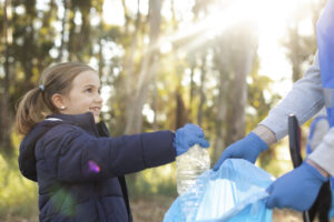 child volunteering at park