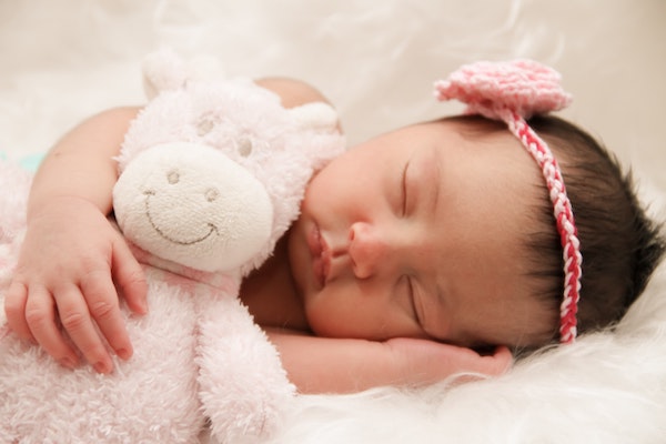 Baby sleeping with stuffed animal
