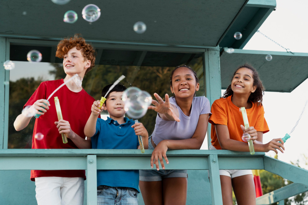 Friends spending some quality time together outdoors blowing bubbles