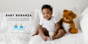 Smiling baby wearing a white onesie sits on a white bed next to a brown teddy bear wearing a diaper. The image includes text that reads “Baby Bonanza – a whirlwind of excitement, education, and expectations” with illustrated baby shoes hanging on a clothesline.